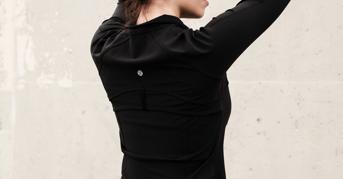 Une femme faisant des étirements avant de courir dans un parc.