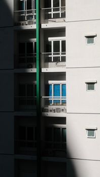 Modern high-rise building showcasing minimalistic design and dramatic lighting.