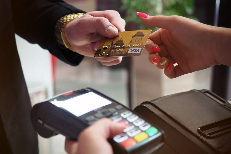 Close-up of a credit card payment being processed at a POS terminal.