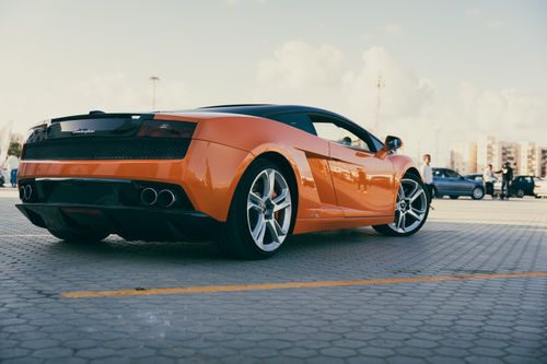 Free Vibrant orange Lamborghini Gallardo parked outdoors in Benghazi, Libya. Stock Photo