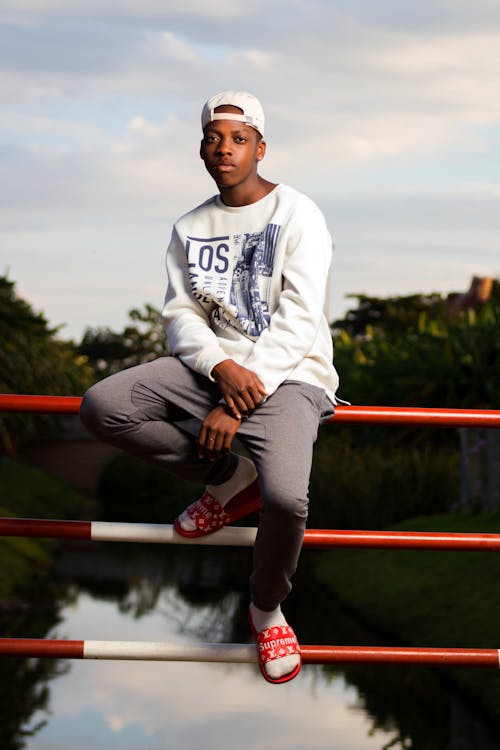 Free Photo Of Man Sitting On Handrail Stock Photo