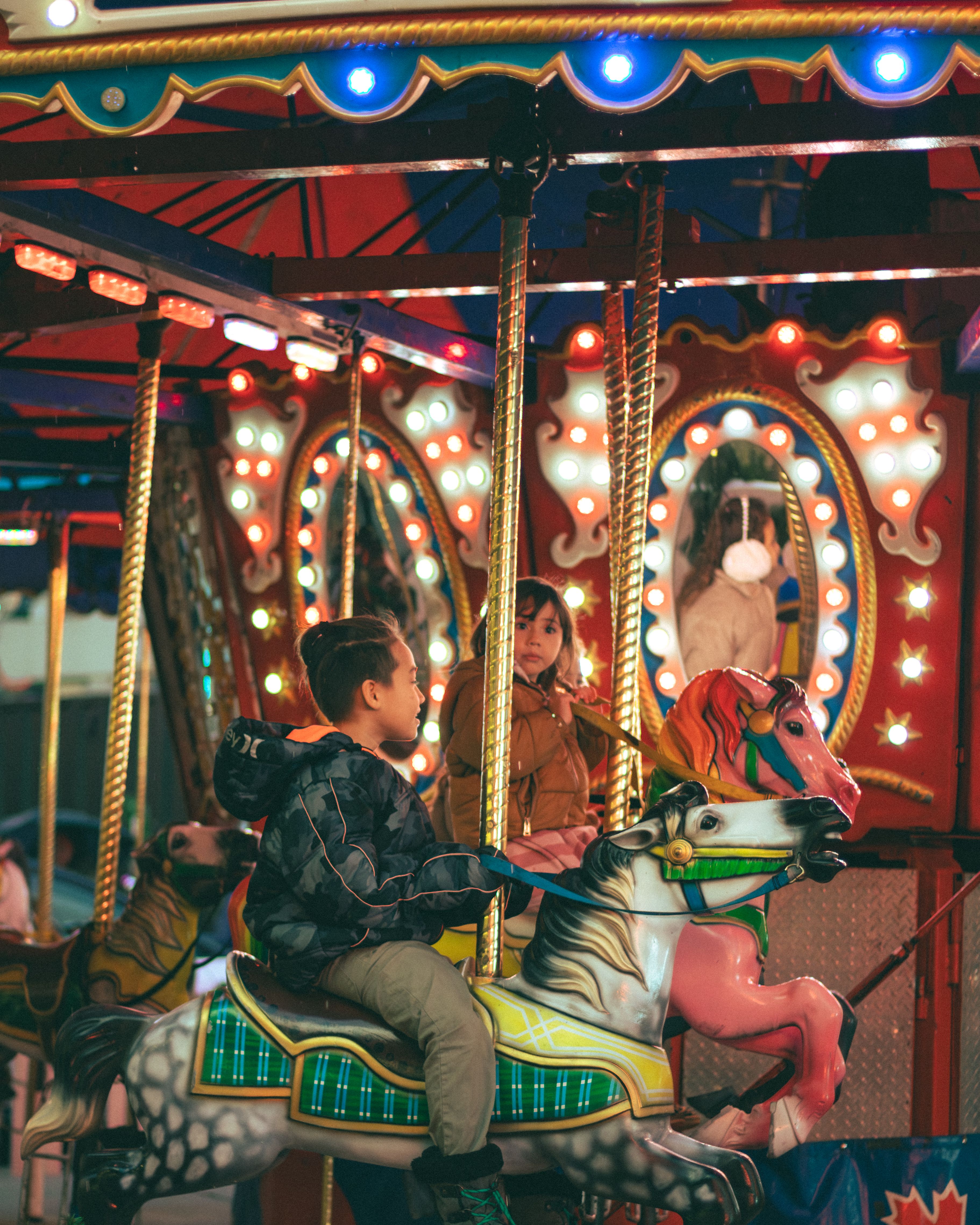 Children Enjoying a Carousel Ride at Night · Free Stock Photo