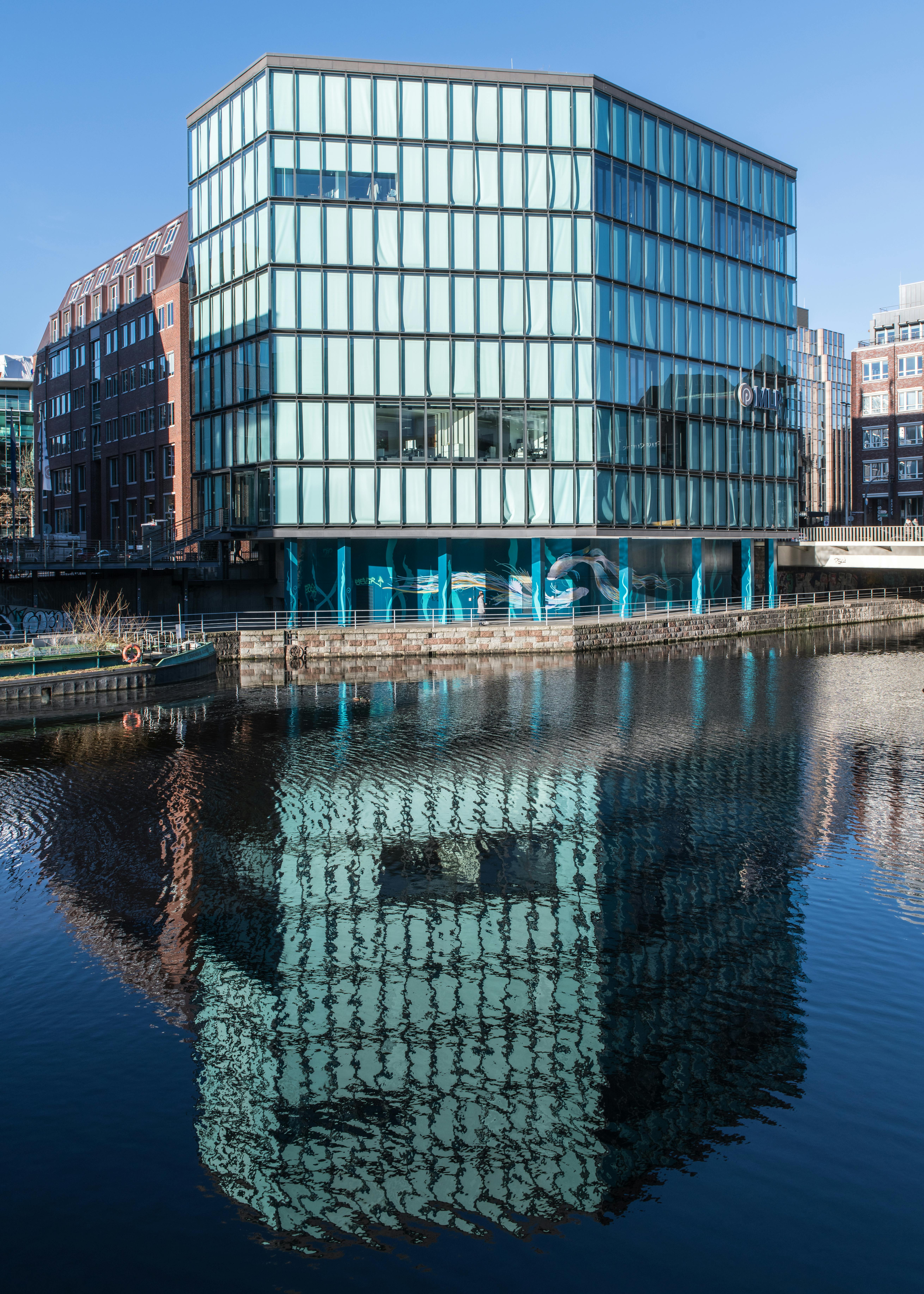 modern office building with canal reflection in hamburg