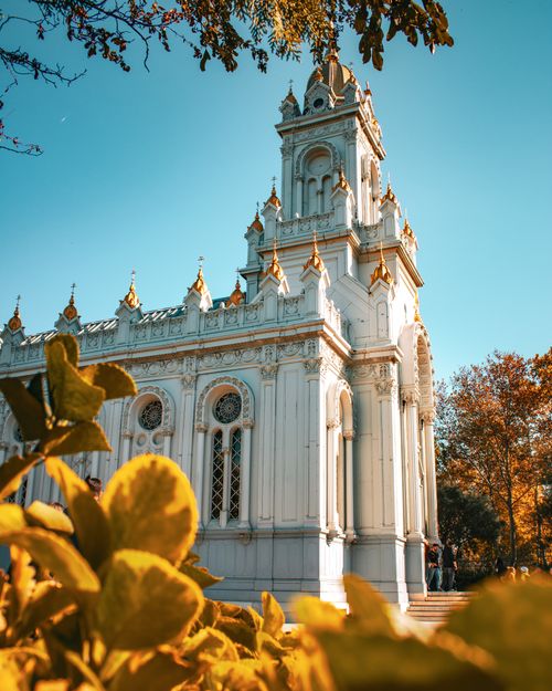 Free Beautiful view of St. Stephen Church in İstanbul on a sunny day, surrounded by vibrant foliage. Stock Photo
