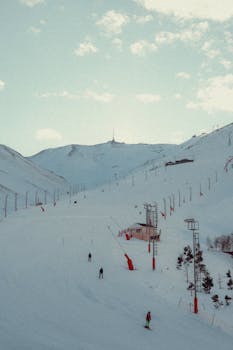 A retro-style ski resort with snowy mountains and ski slopes. Perfect winter getaway landscape.
