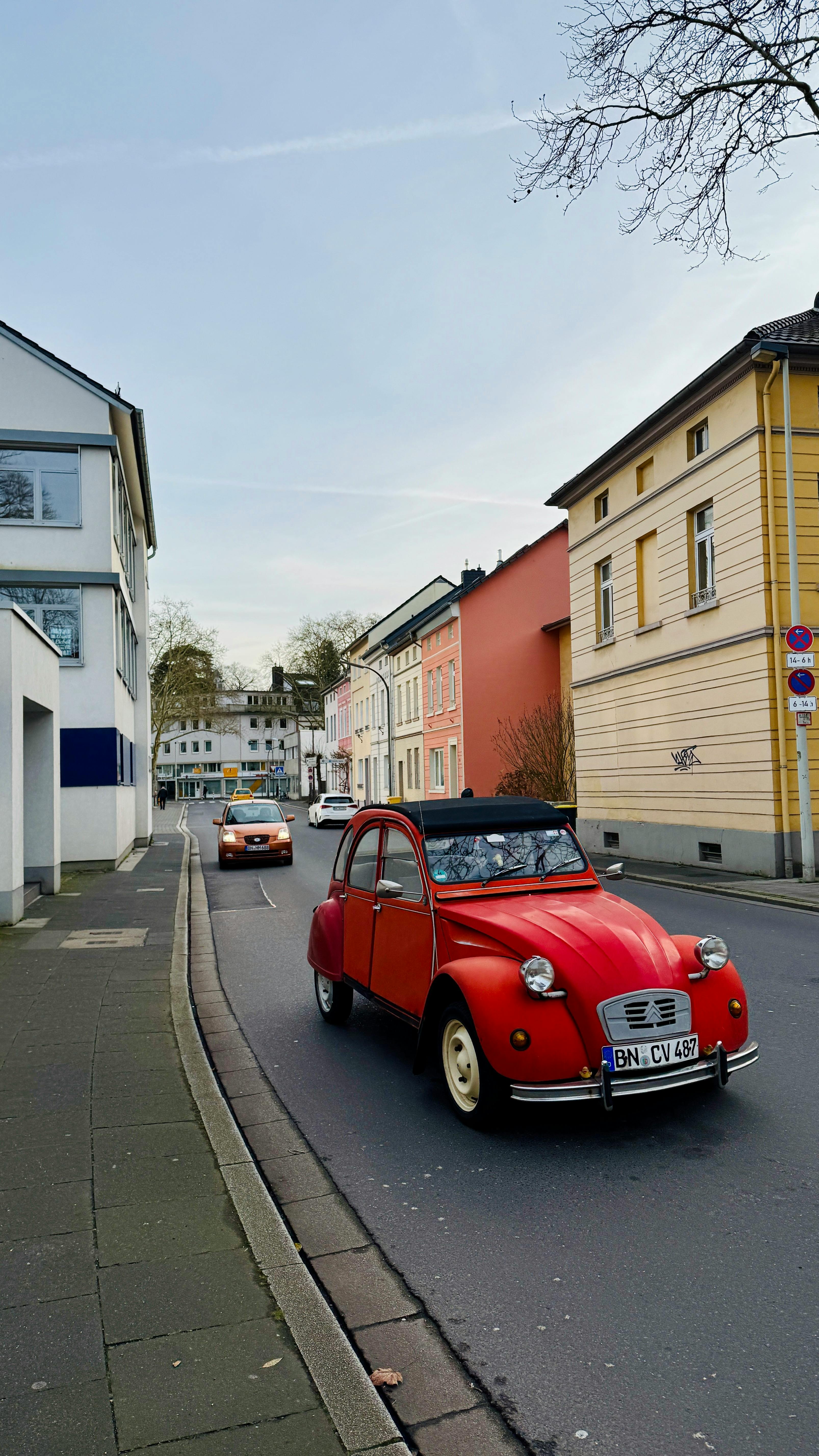 colorful urban street with vintage red car