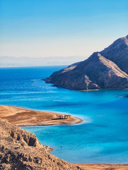 Free Stunning coastal landscape with azure waters and rugged mountains, perfect for travel enthusiasts. Stock Photo