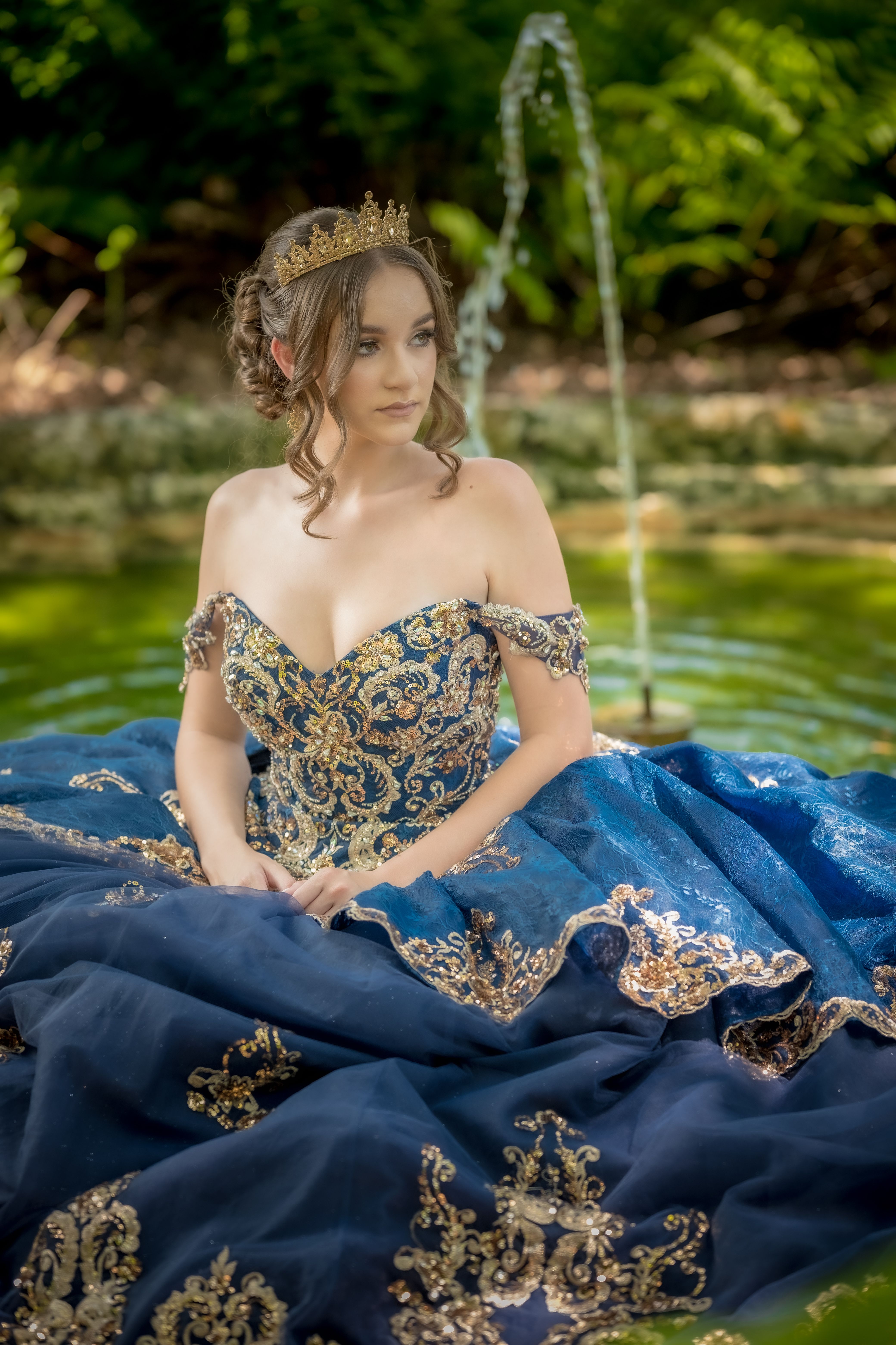 Elegant Woman in Ornate Blue Gown by Fountain · Free Stock Photo