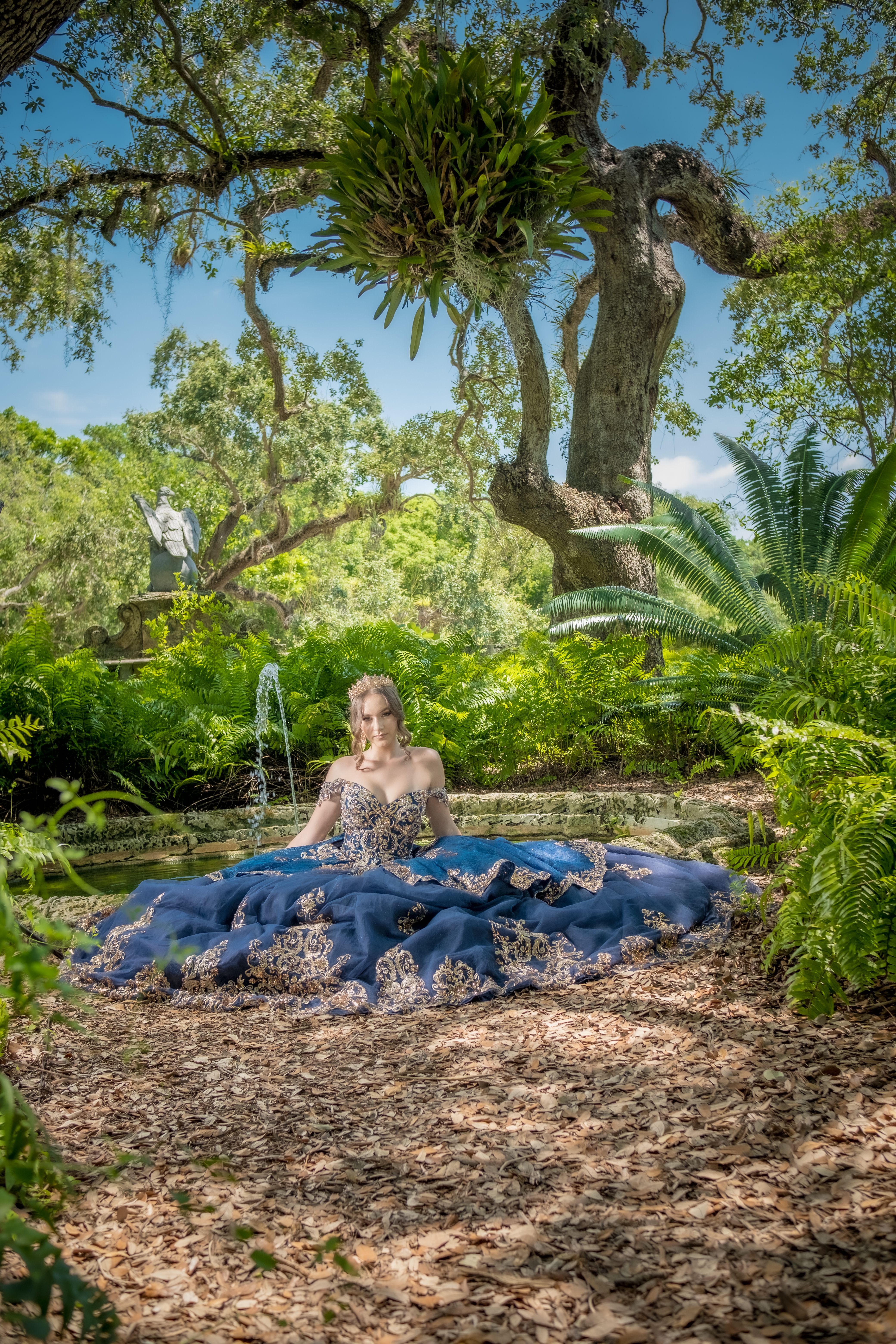 Elegant Woman in Blue Gown in Serene Garden · Free Stock Photo