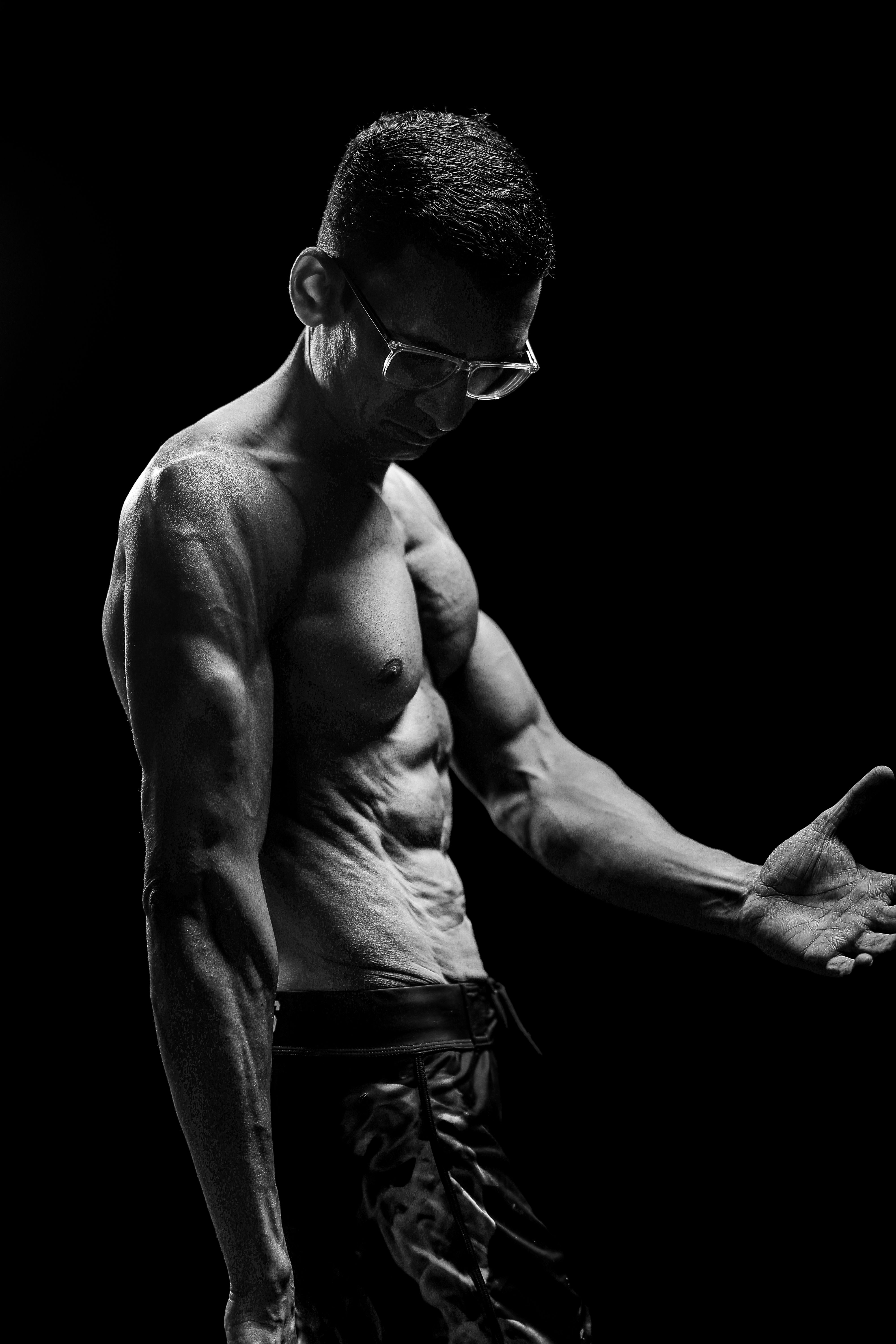 Black and White Portrait of Muscular Man in Glasses · Free Stock Photo