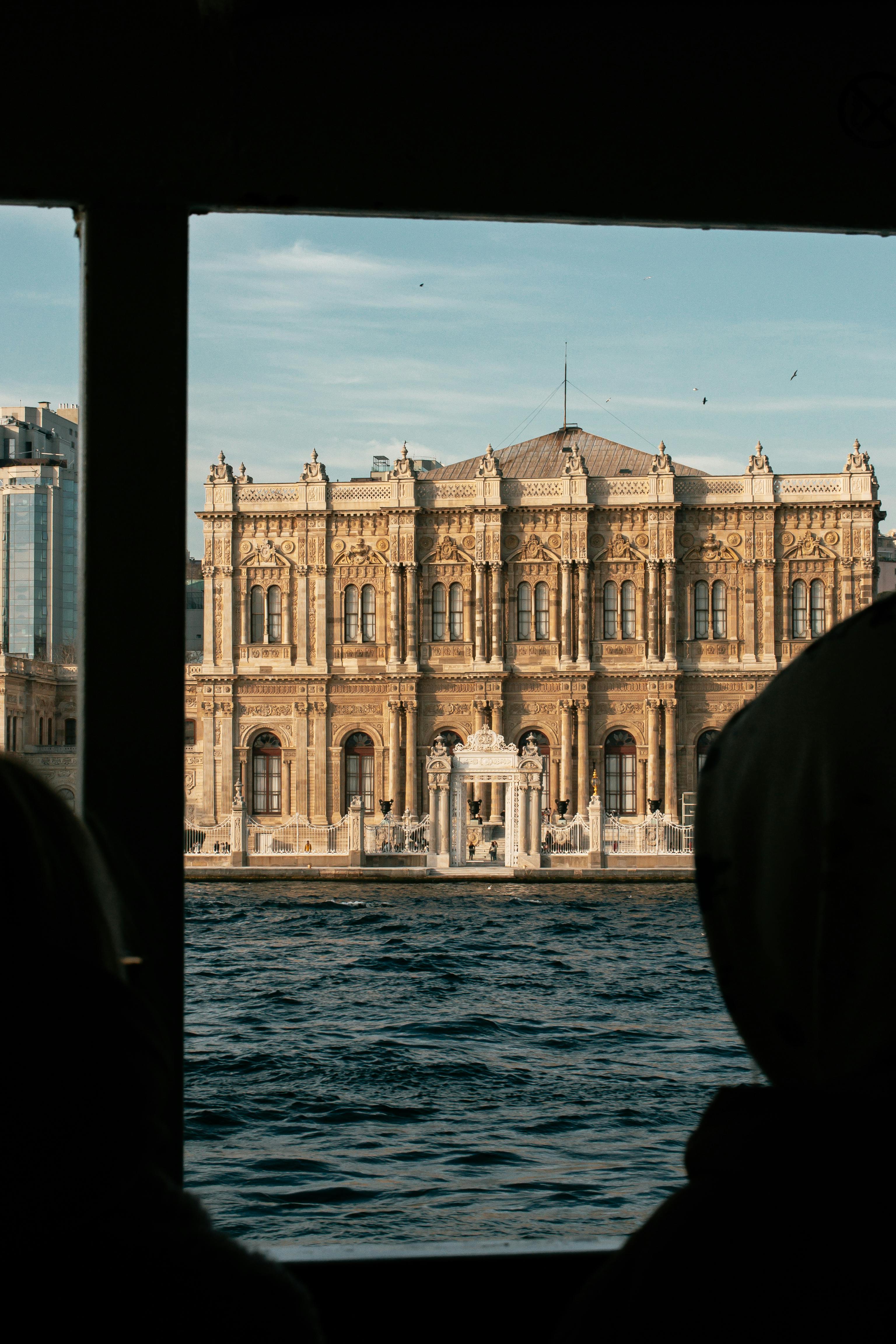 Captured from a ferry, the majestic Dolmabahçe Palace stands by the Bosphorus in Istanbul.