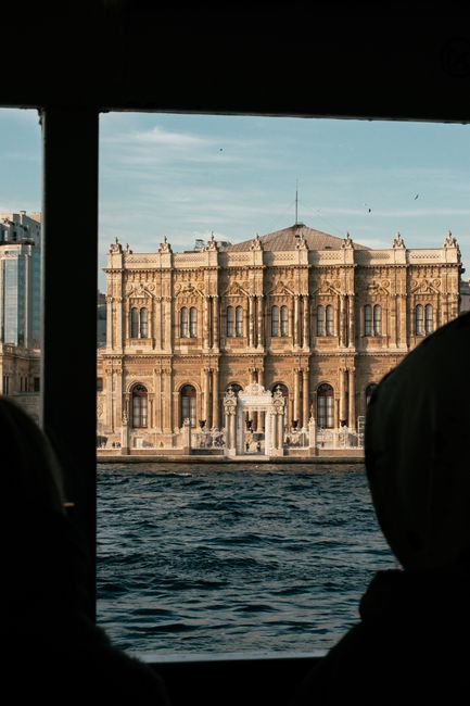 Captured from a ferry, the majestic Dolmabahçe Palace stands by the Bosphorus in Istanbul.