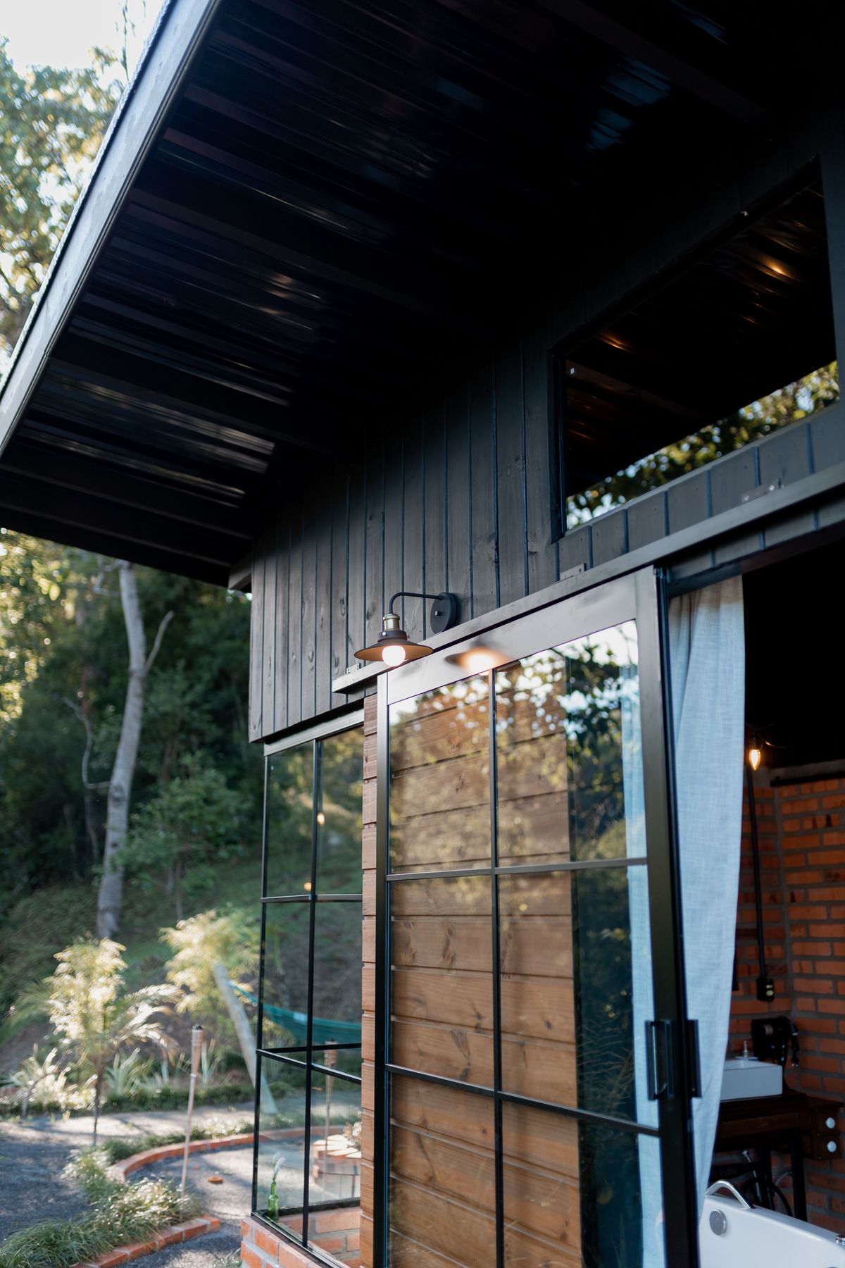 Modern home exterior combining glass and natural wood cladding