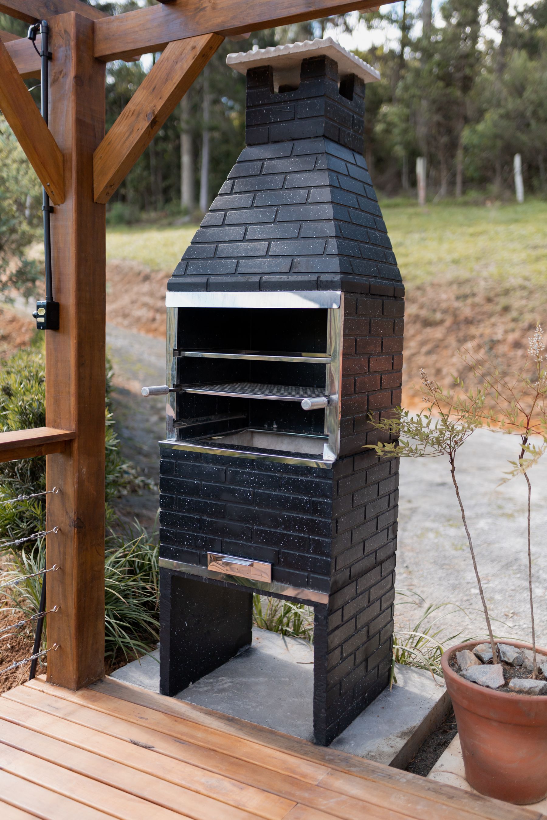 Built outdoor barbecue cooking station positioned on a wooden residential deck