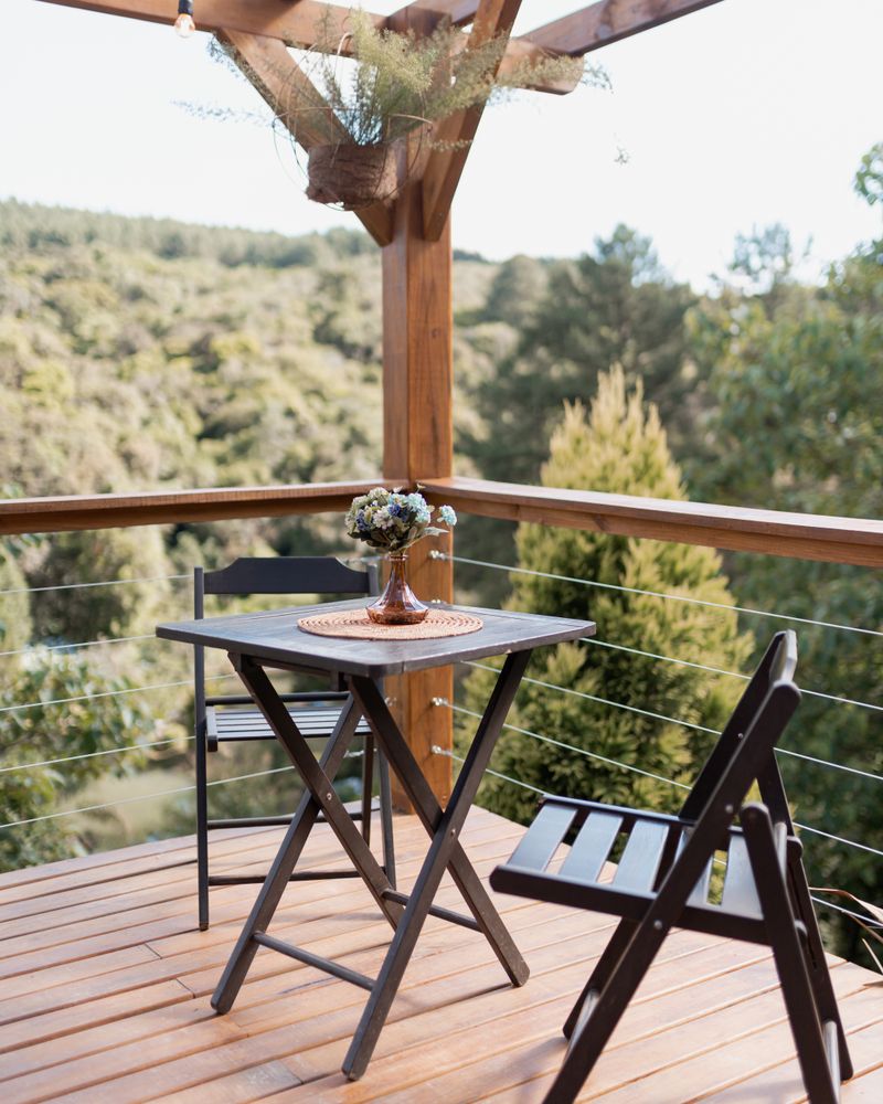 Elevated deck with pergola and forest view