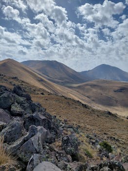 Breathtaking view of rocky mountain terrain under cloudy sky.
