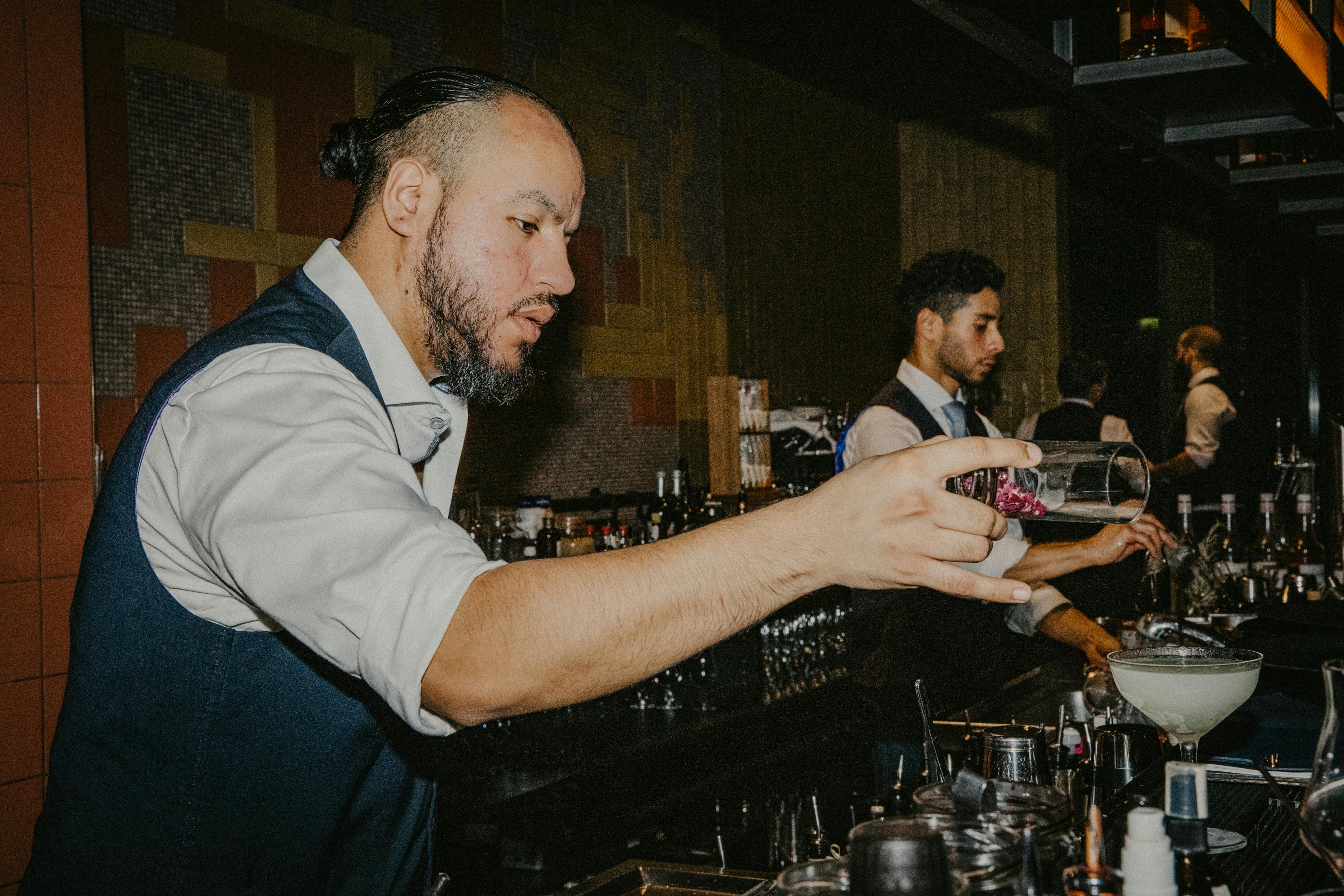 professional bartenders crafting cocktails at night