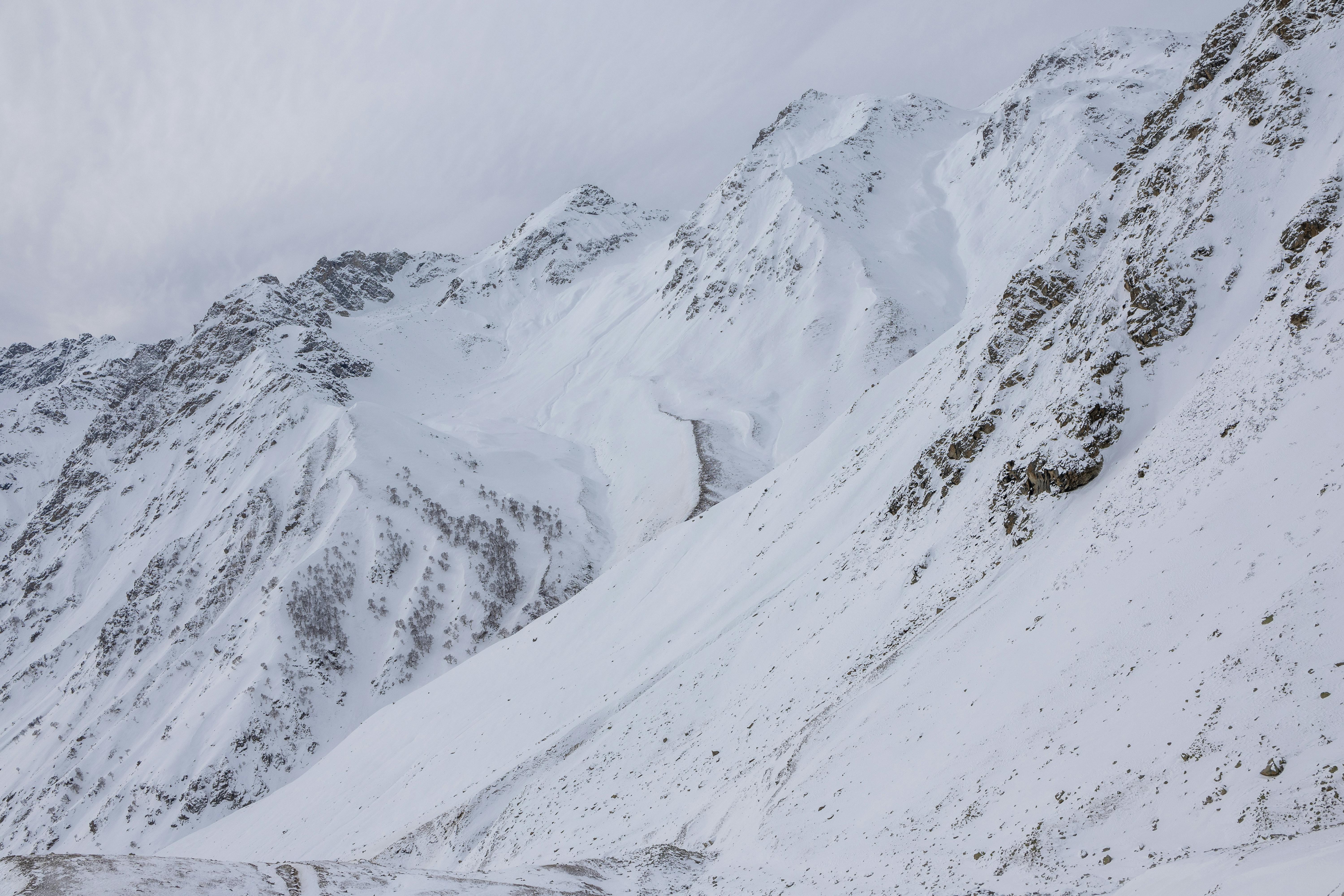Majestic snow-covered mountain peaks showcasing winter beauty in high altitude landscapes.