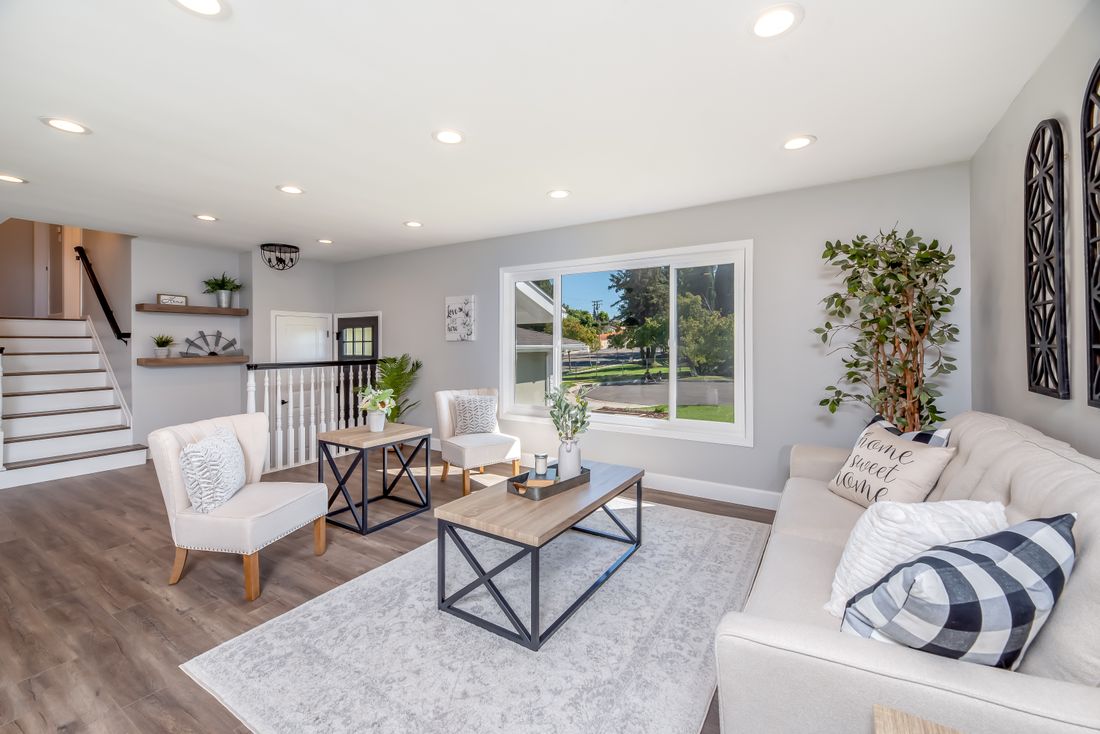 Contemporary living room with a large window and a scenic view