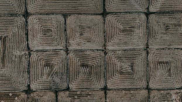 Drone shot capturing the geometric patterns of plowed agricultural fields.