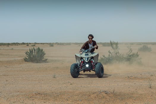 An adventurous ATV rider navigating the rugged desert landscape in Riyadh, Saudi Arabia.