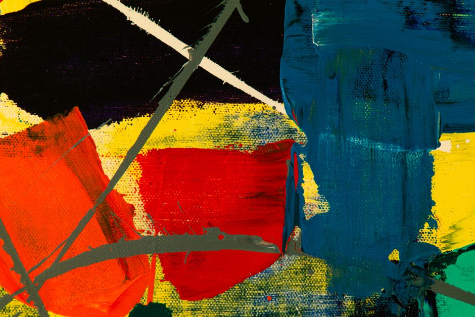 Dynamic abstract painting with bold colors and textures on canvas.