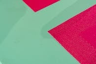 Close-up of Red Placemat on Teal Surface