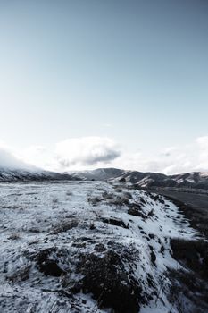 Breathtaking snowy mountains under a vast cloudy sky, perfect for winter travel themes.