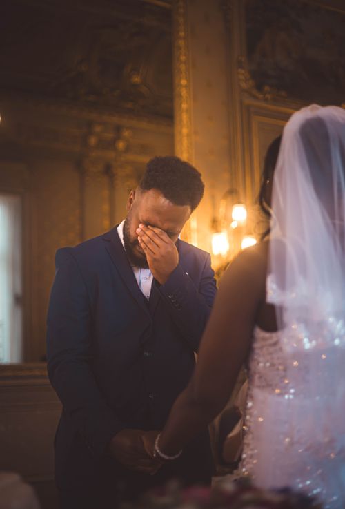 Free Bride and groom share an emotional moment during a wedding ceremony indoors. Stock Photo