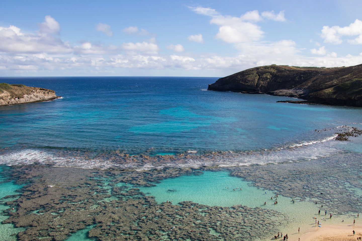 The crescent of Hanauma Bay on Oʻahu seen from the overlook, reef visible through the shallows