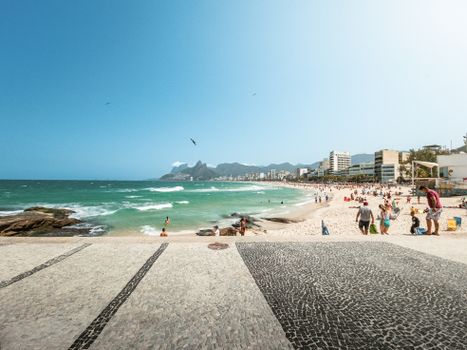 Explore the vibrant Ipanema Beach in Rio de Janeiro with its stunning seascape and lively atmosphere.