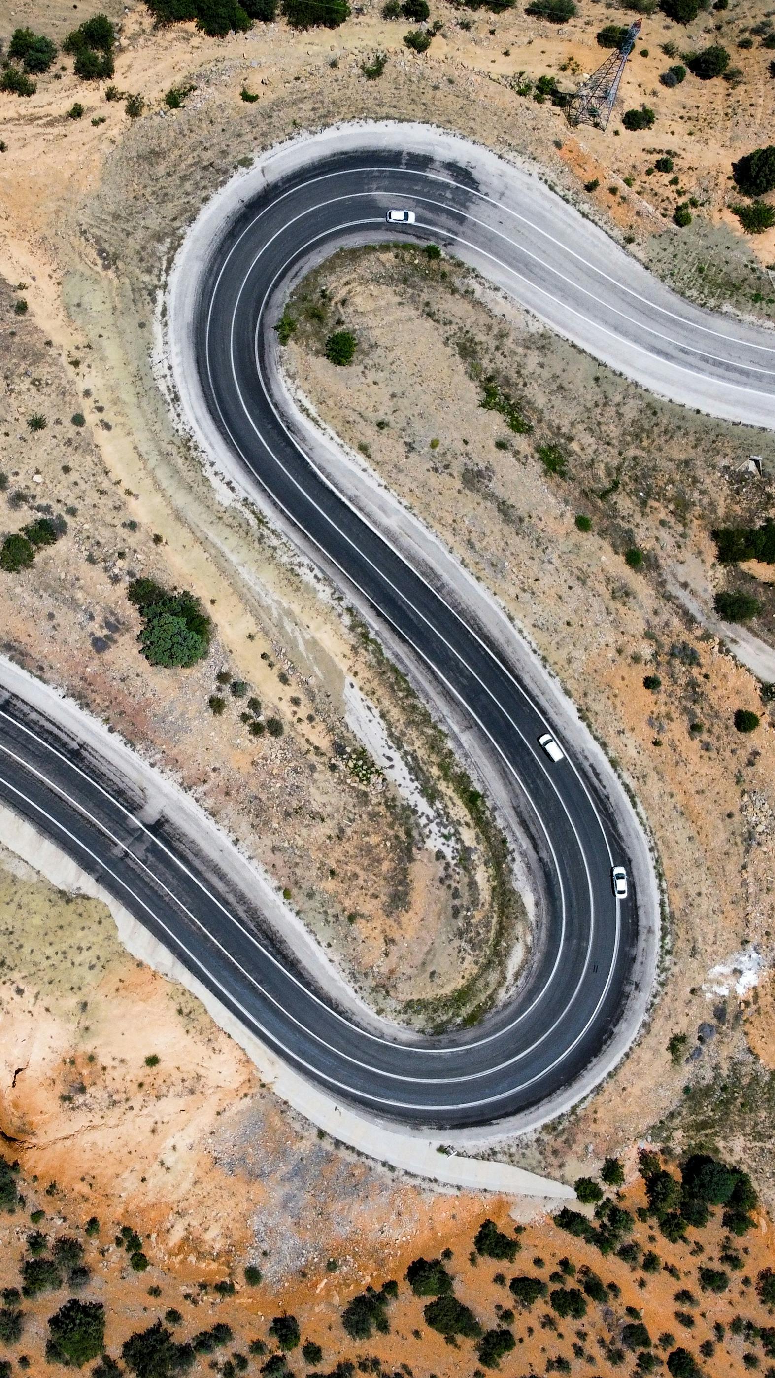 A stunning aerial photo of a winding mountain road in Türkiye, showcasing nature's curves.
