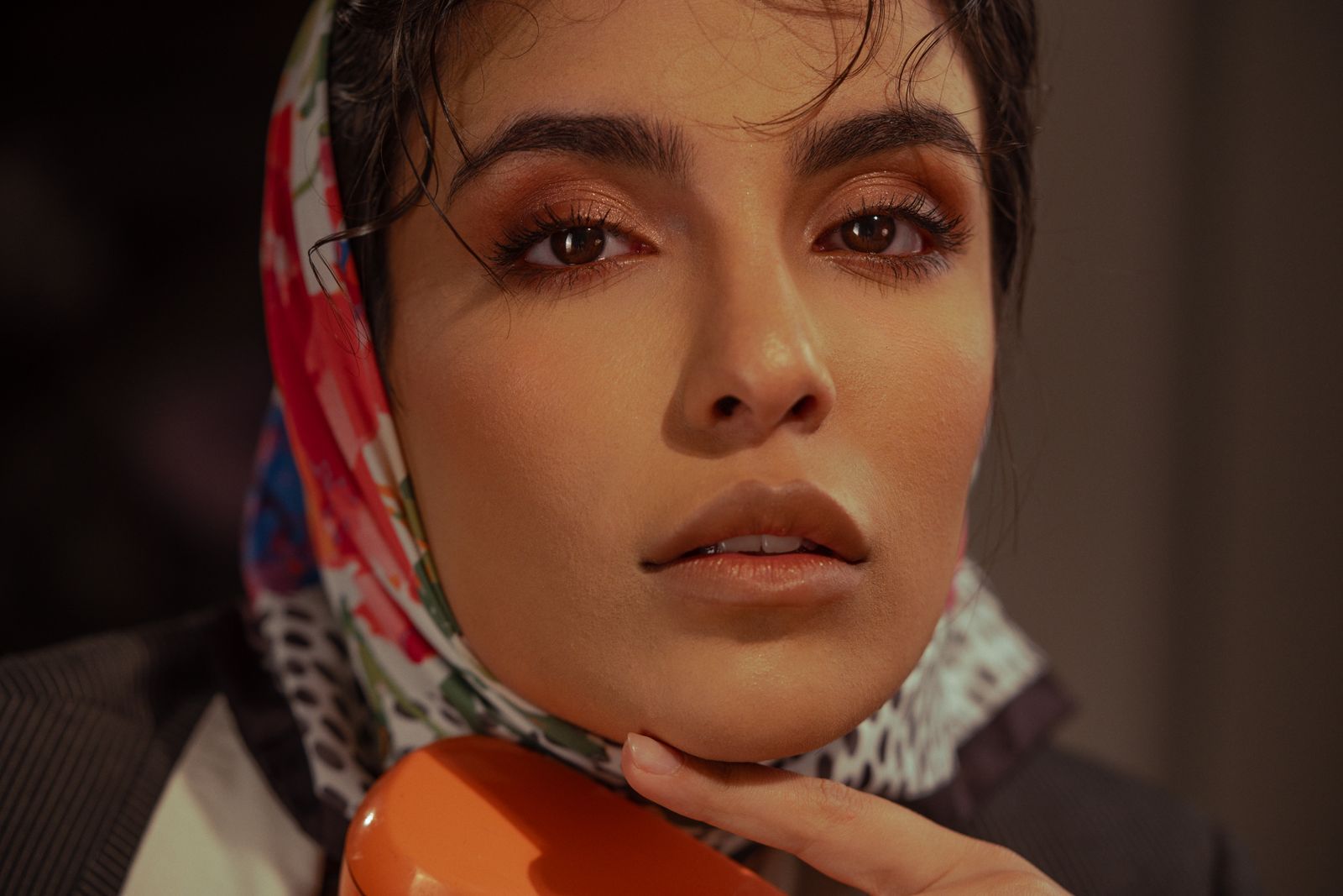 Intimate close-up of a woman wearing a vibrant scarf, highlighting natural beauty.