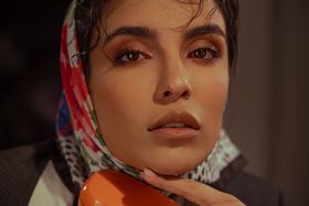 Intimate close-up of a woman wearing a vibrant scarf, highlighting natural beauty.