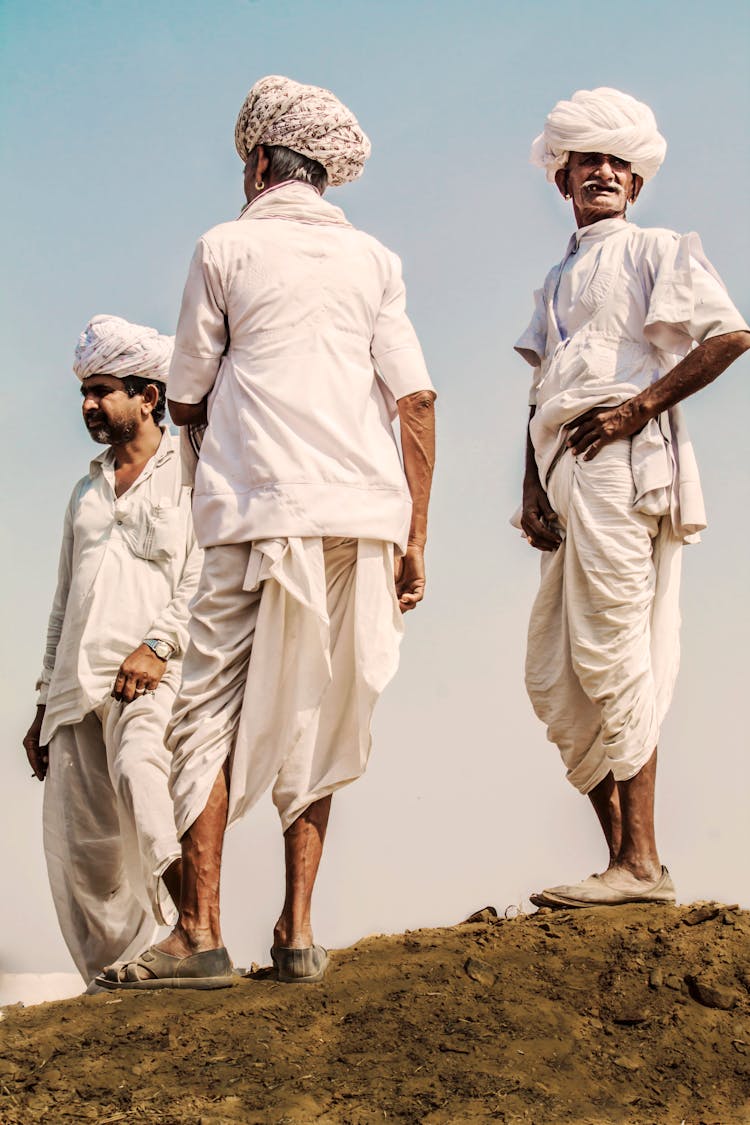 Three Men Standing On Hill