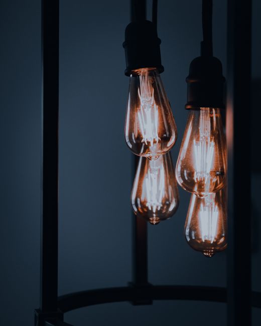 Close-up view of vintage Edison light bulbs, creating a warm ambiance in a dark interior setting.