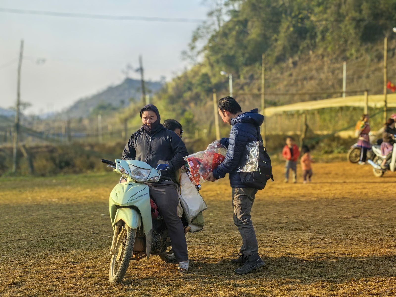 Vietnam village scene with locals and motorbike showing the human memories guests often mention after Ha Giang