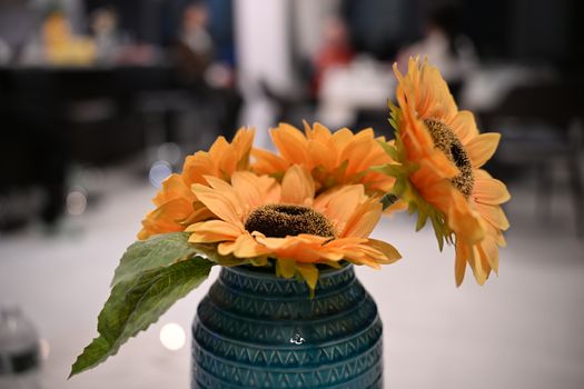 Vibrant sunflowers in a detailed blue vase, adding warmth indoors.