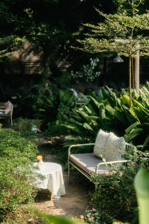Free Peaceful garden view with seating area in lush greenery in Lạng Sơn, Việt Nam. Stock Photo