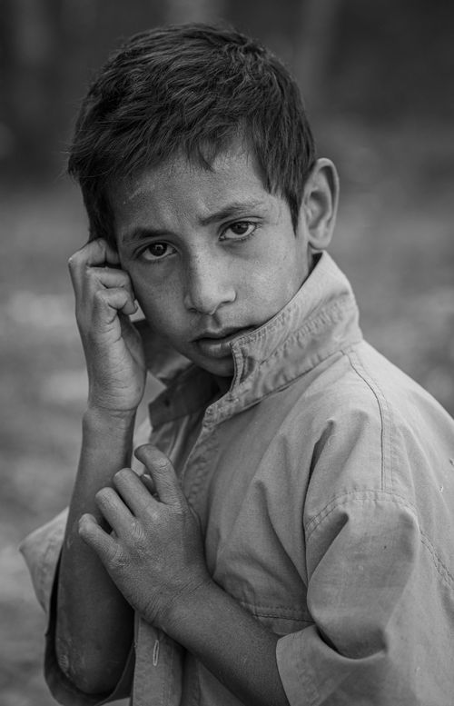 Free A touching black and white portrait capturing the candid innocence of a young boy from a rural village. Stock Photo