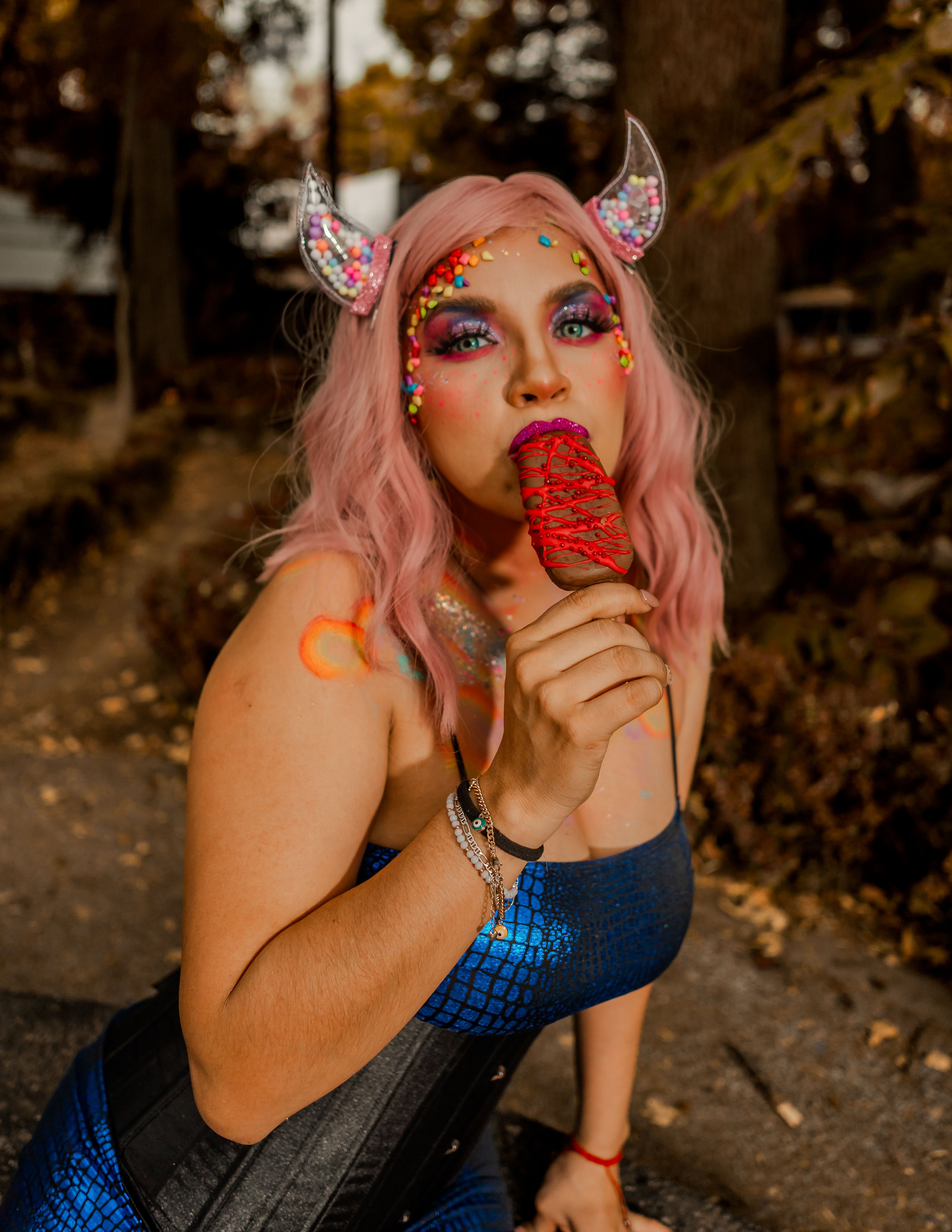 A colorful surreal portrait featuring creative makeup and a whimsical outfit, outdoors in Mexico City.