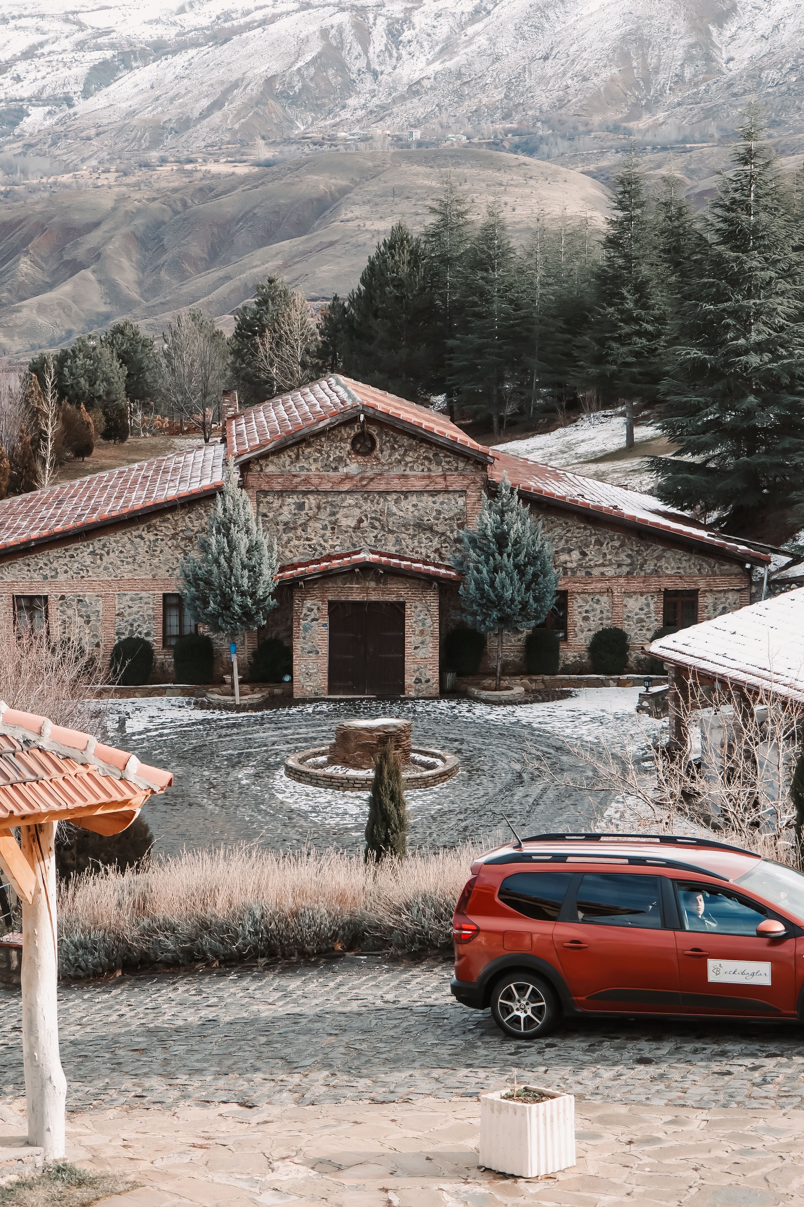 Rustic Stone House with Snowy Mountain Background · Free Stock Photo