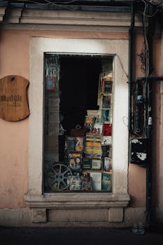 Explore a nostalgic movie shop window in Istanbul filled with DVDs and retro film memorabilia.