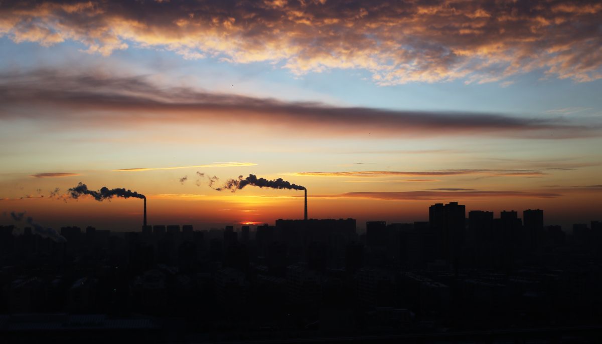 Industrial Cityscape with Smokestacks at Sunset · Free Stock Photo