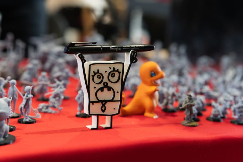 Designer toy figurines on display at a convention showing art toy world building and the collectible universe of the Zombie Party lore