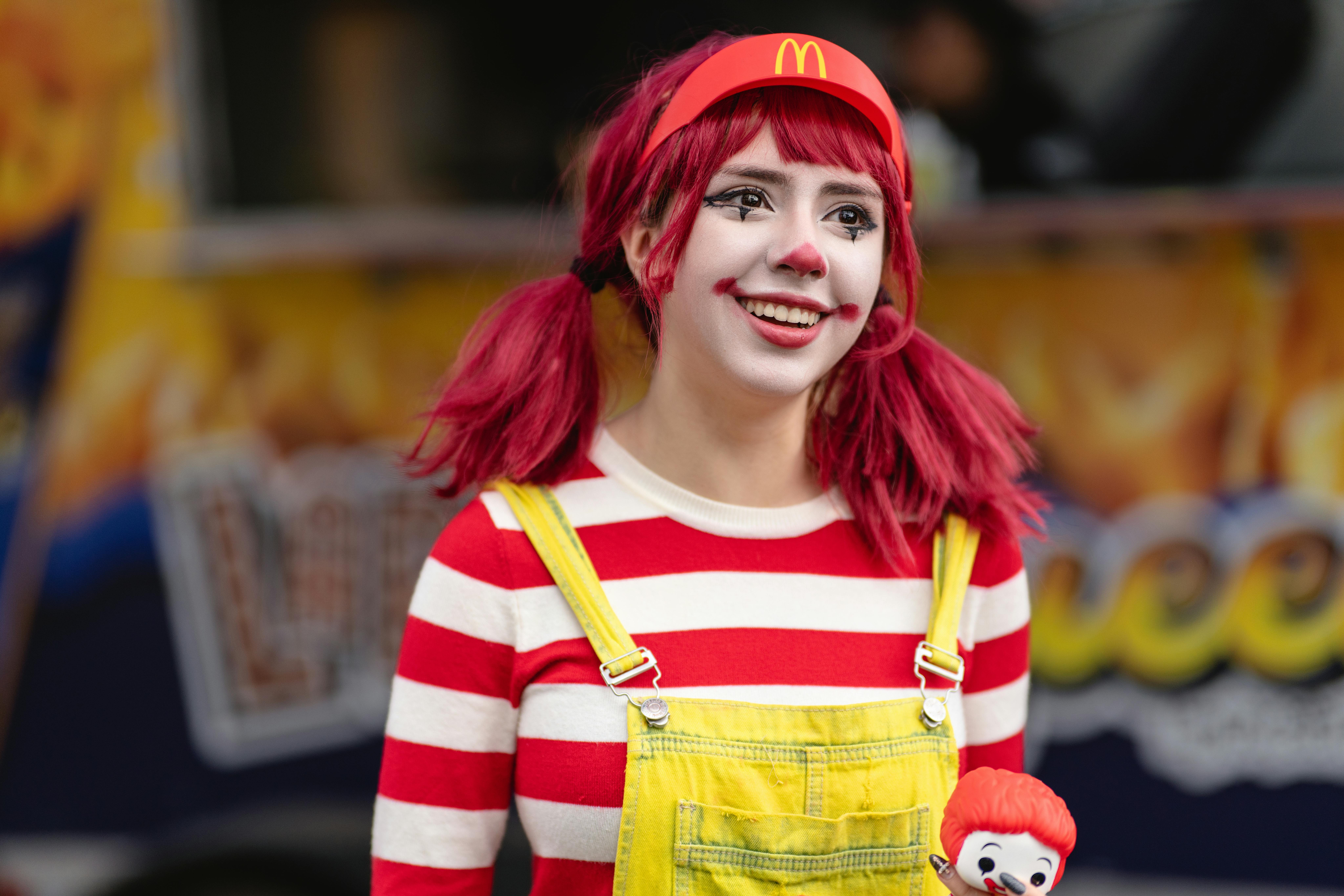 Young woman in bright cosplay of a fast food mascot smiling outdoors.