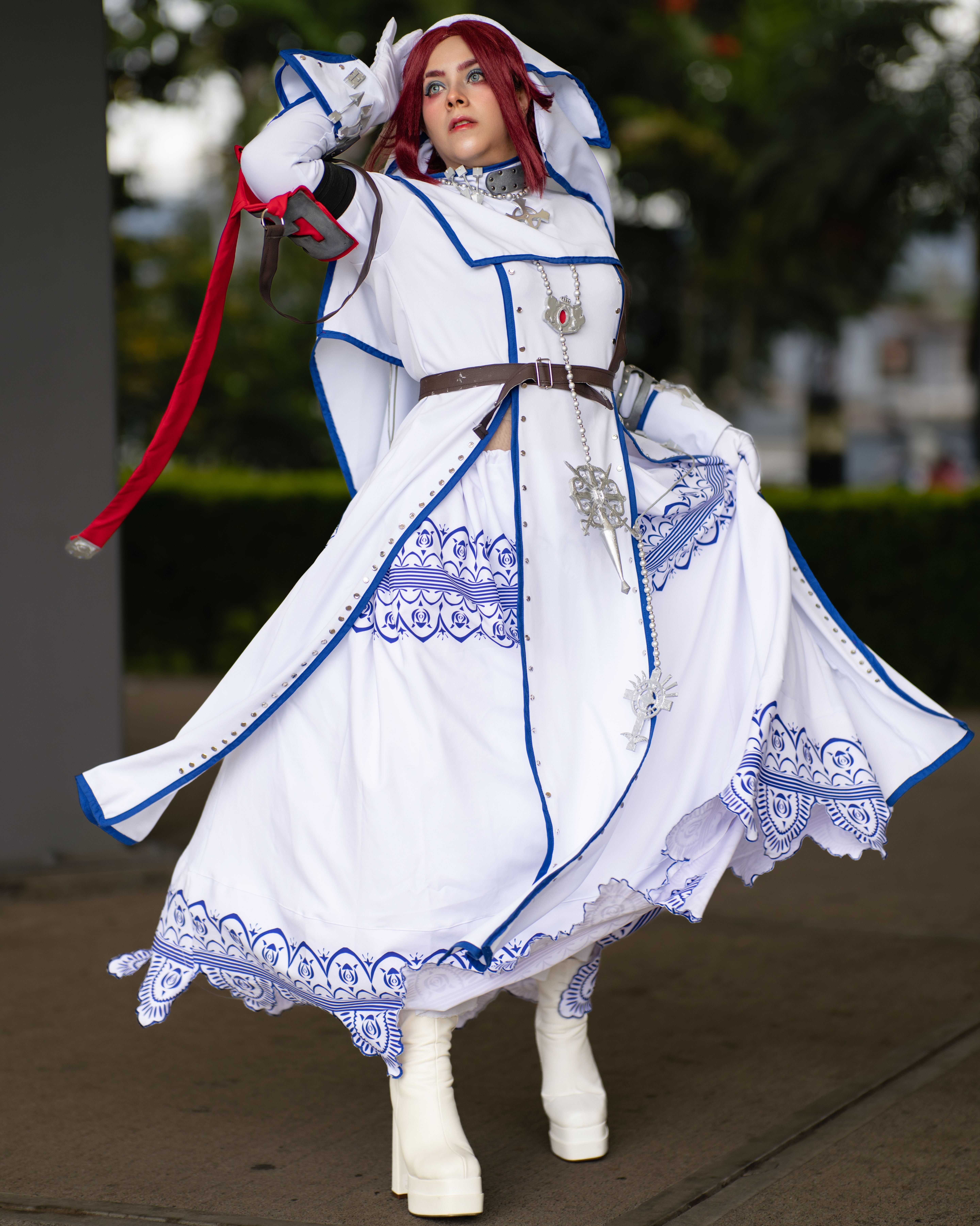 Graceful pose of a cosplayer in detailed costume at San José anime event.