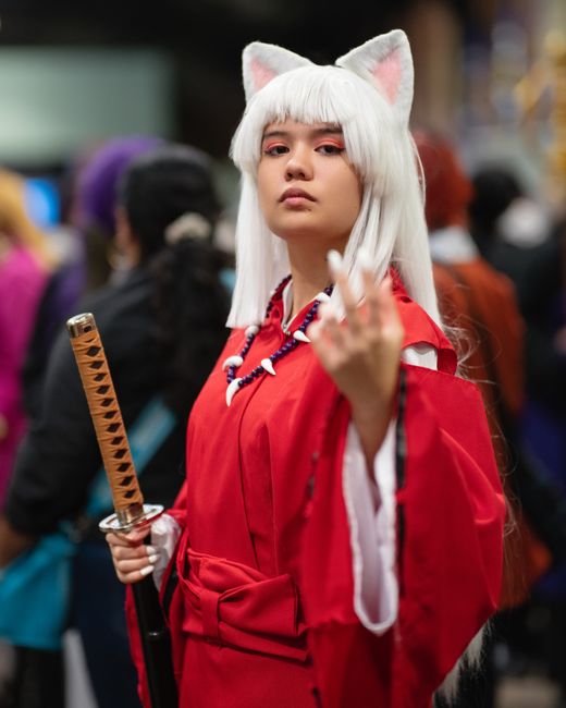 Anime cosplay enthusiast in traditional attire at a vibrant Costa Rica convention.