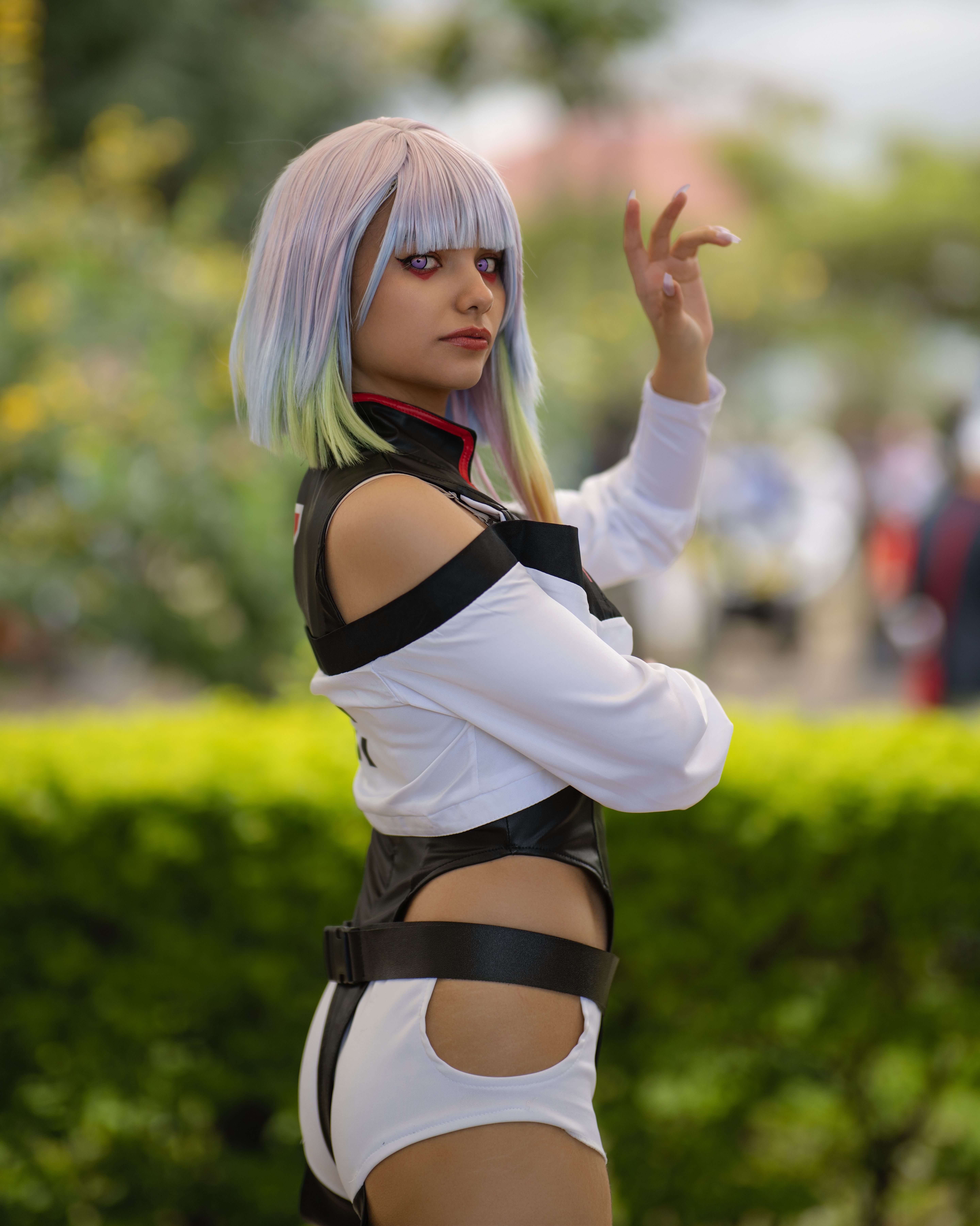 A striking anime cosplay character poses in a lush San José garden, Costa Rica.