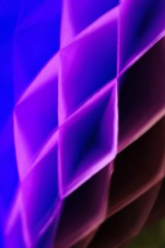 Vivid abstract image showcasing a geometric pattern with vibrant purple and blue hues.